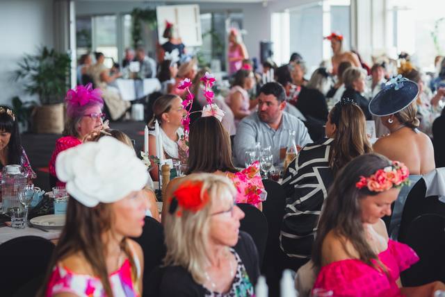 A full table of guests in racing colours